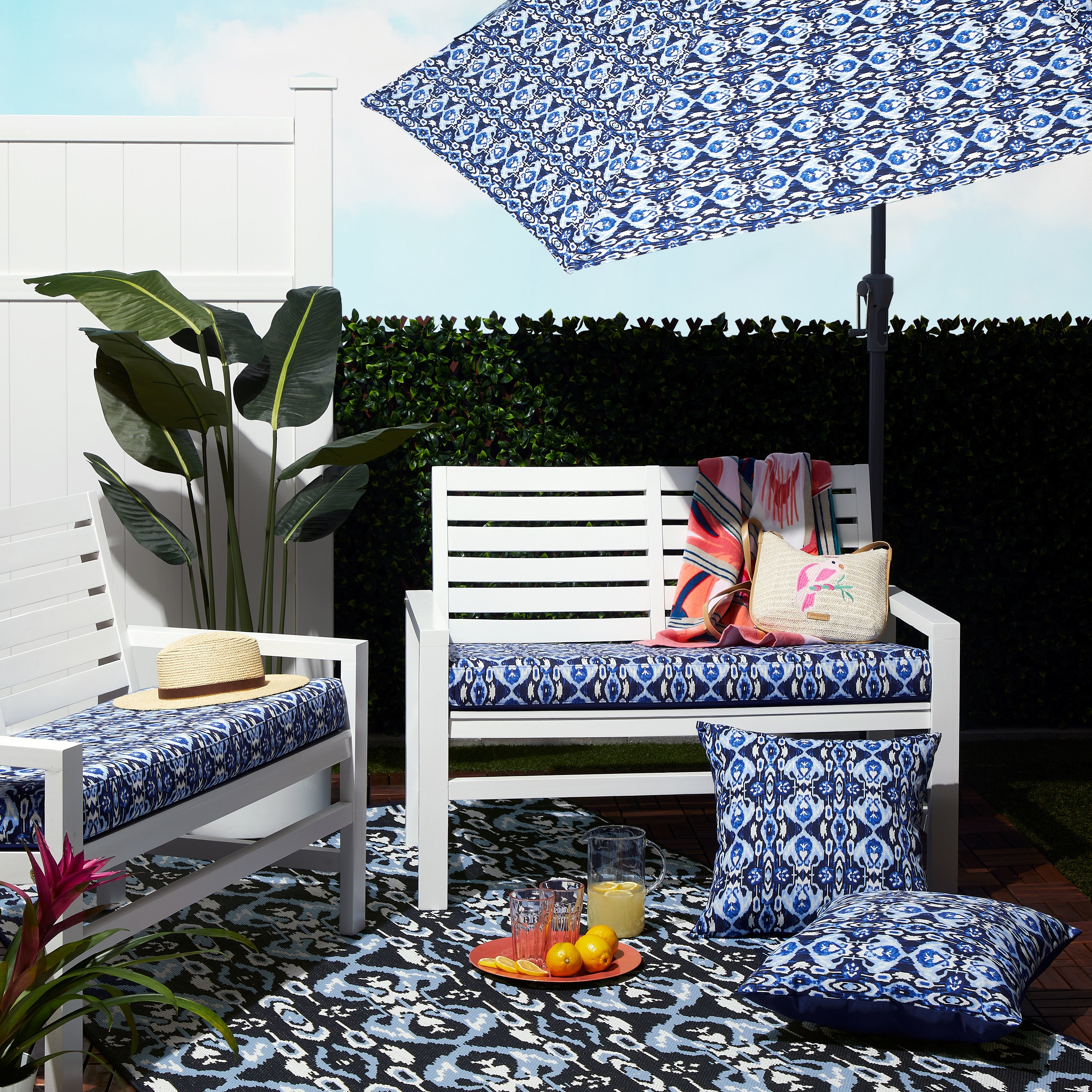 62-1XX_PATIO_VeraBradley_FoamBench_AccentPillow_Umbrella_IkatIsland_Lifestyle_Group.jpg