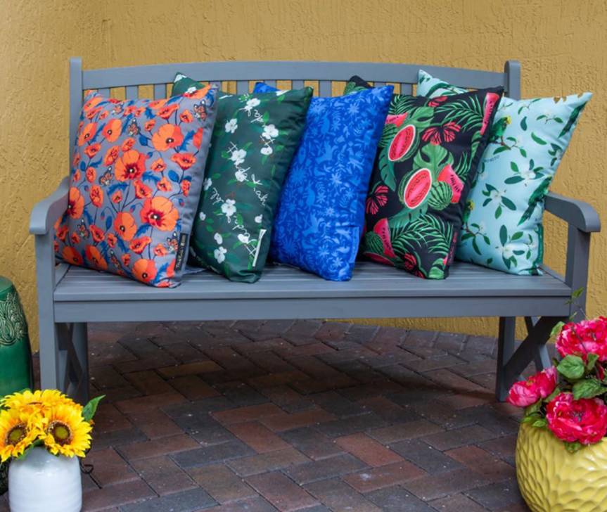 The Patio Essentials for Spring from The Frida Kahlo Collection featuring cushions on an outdoor bench 